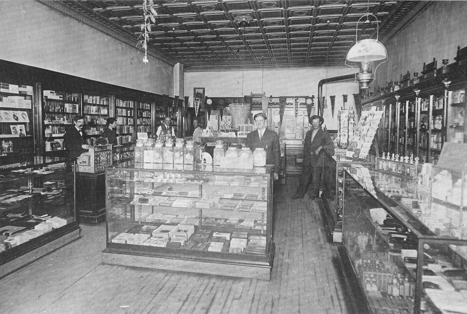 Smith's Drug Store 1913. Left to Right: Tom Smith, Belle Smith, Dr George Smith, customer, Mr Moser (clerk), customer